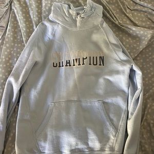 light blue champion hoodie with navy and white writing